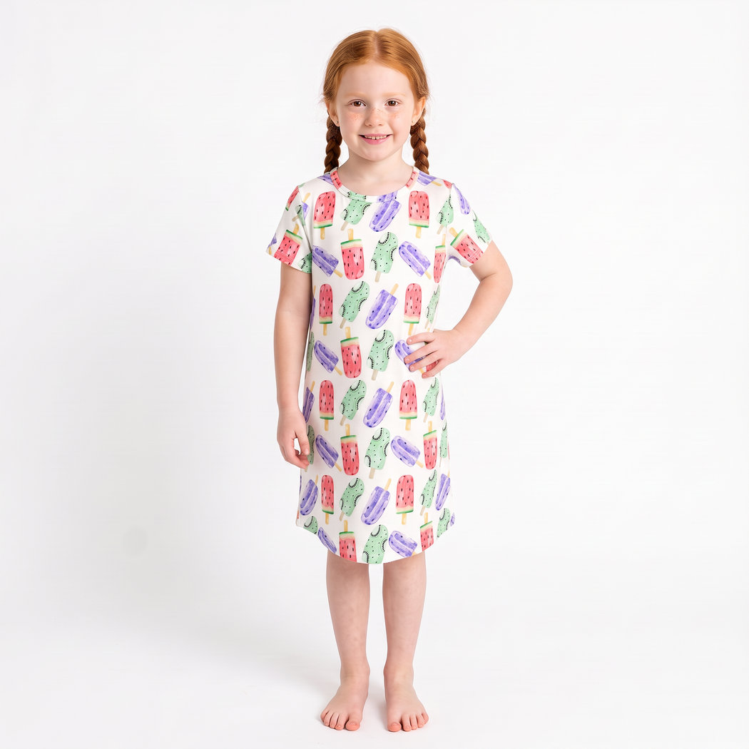 Girl wearing Popsicle Kids Snuggle Dress in watercolour popsicle print, three-quarter pose