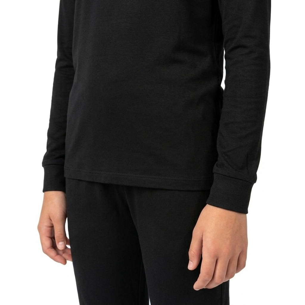 Detail of PIKA solid black bamboo pyjama set showing loose hem and ribbed cuff