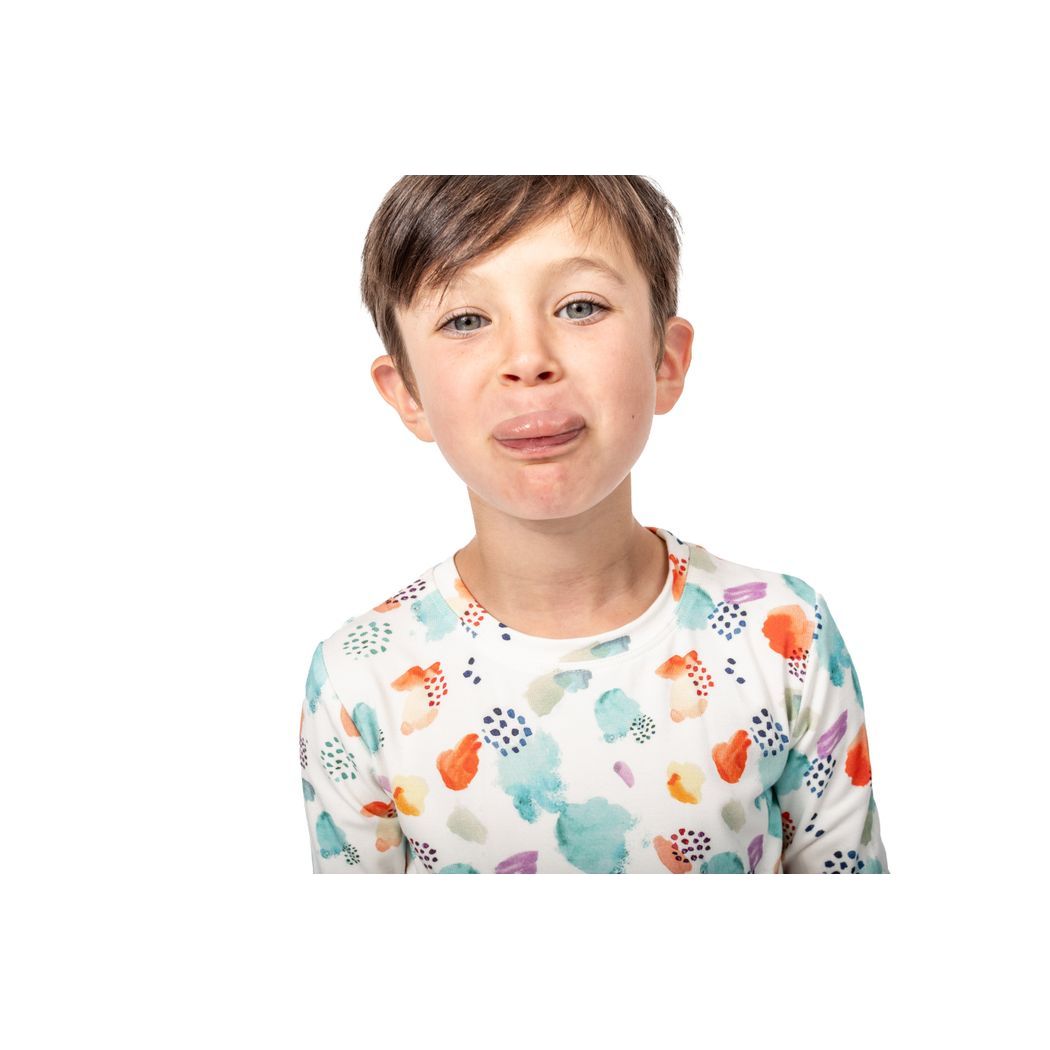 Child wearing a colorful patterned shirt on a white background