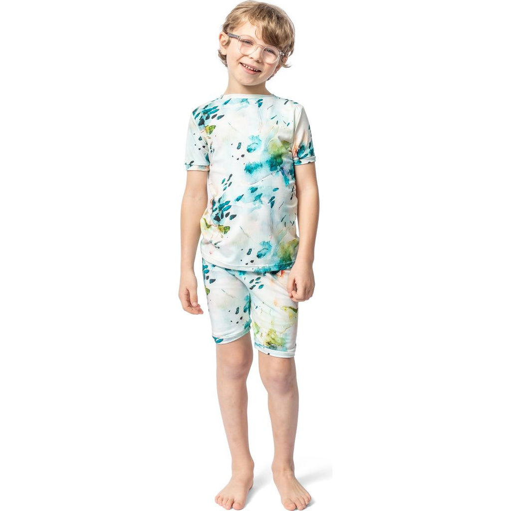 A child wearing a floral Aurora Bamboo Shorties PJ Set, standing against a white background.