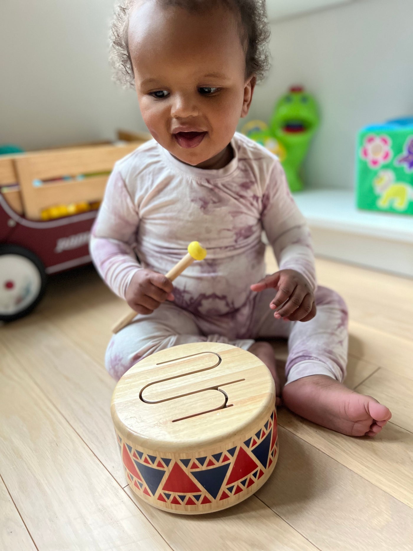 Baby with drum in pink pj