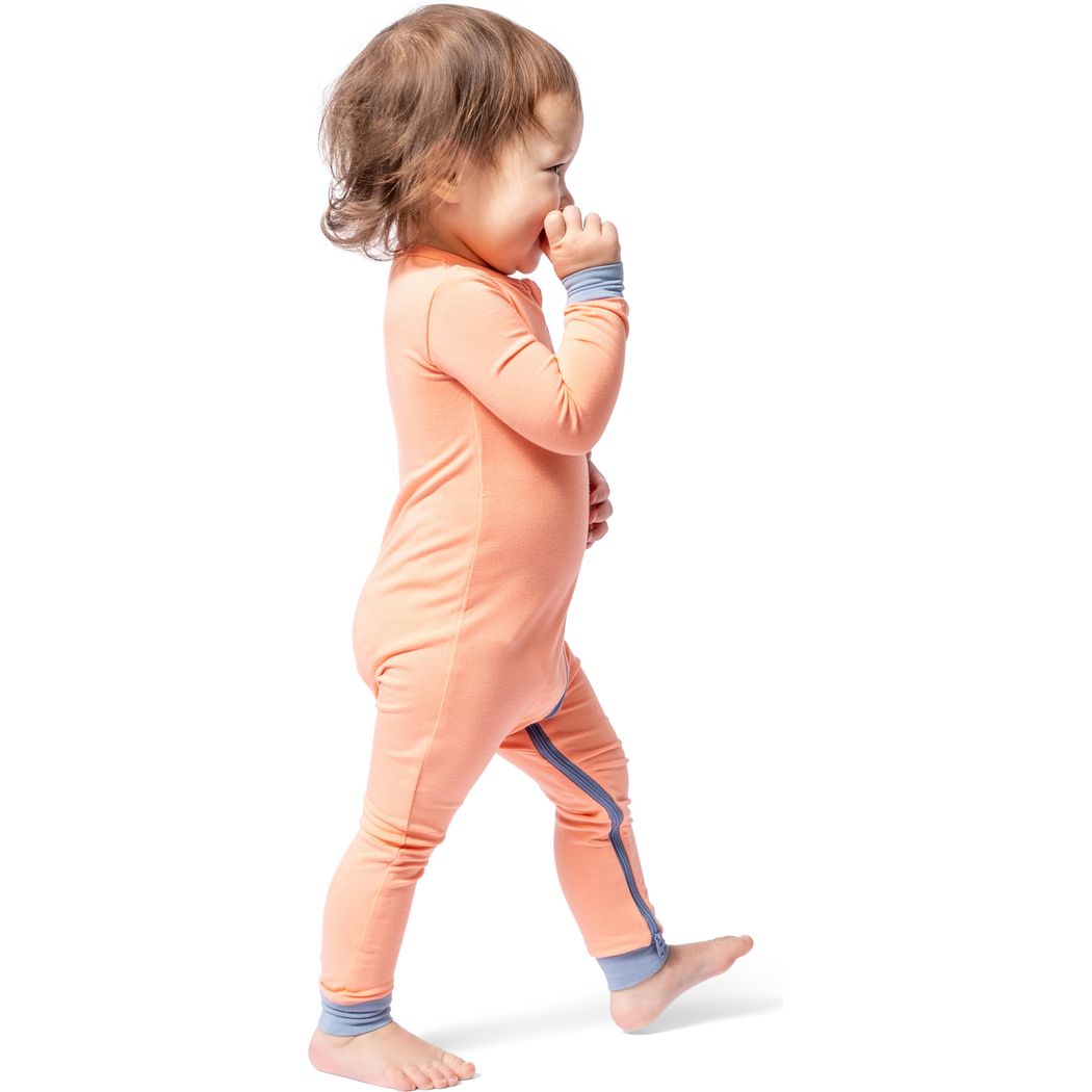 Toddler wearing Apricot Bamboo Zip Sleeper in orange, side view