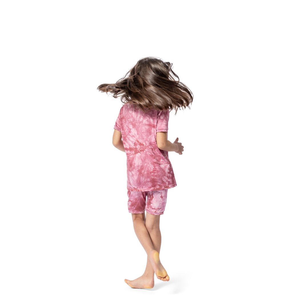 Girl wearing Berry Tie Dye Bamboo Shorties PJ Set in pink, side view