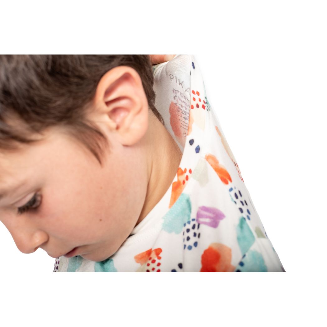 Close-up detail of boy wearing Confetti Cloud Kids Bamboo PJs in multicolor