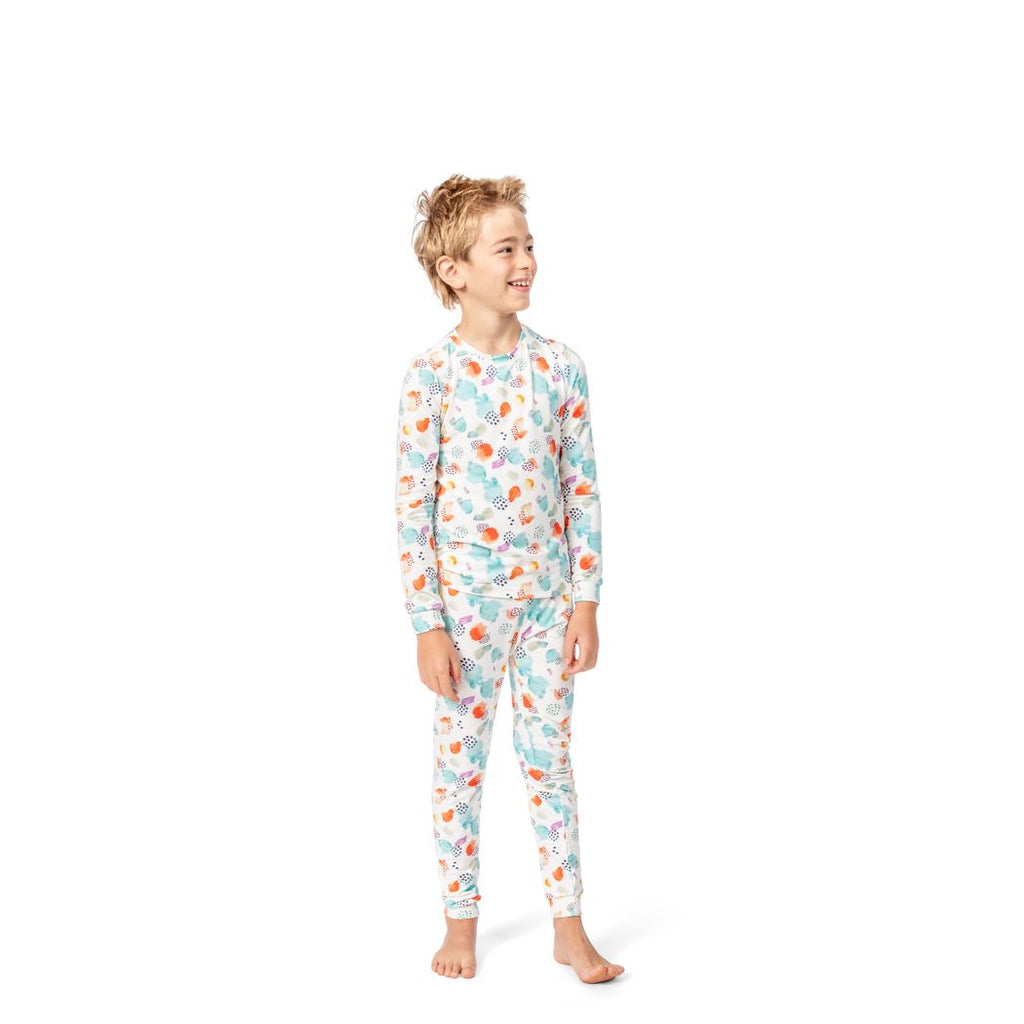 Boy wearing Confetti Cloud Kids Bamboo PJs in multicolor, front view
