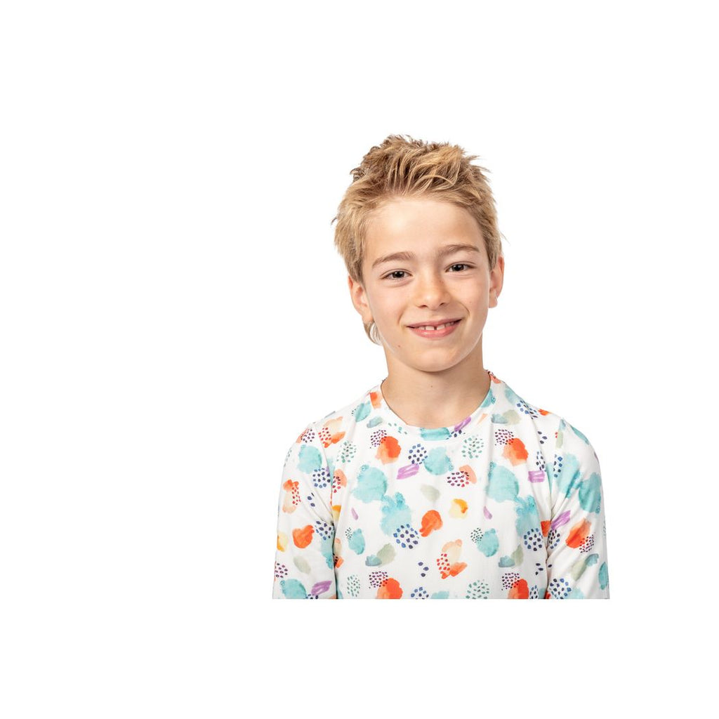 Boy wearing Confetti Cloud Kids Bamboo PJs in multicolor, front view