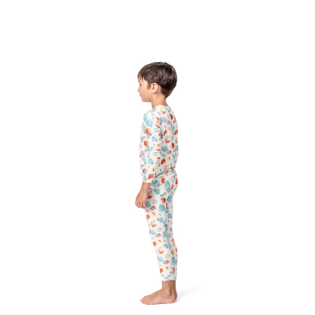 Boy wearing Confetti Cloud Kids Bamboo PJs in multicolor, side view