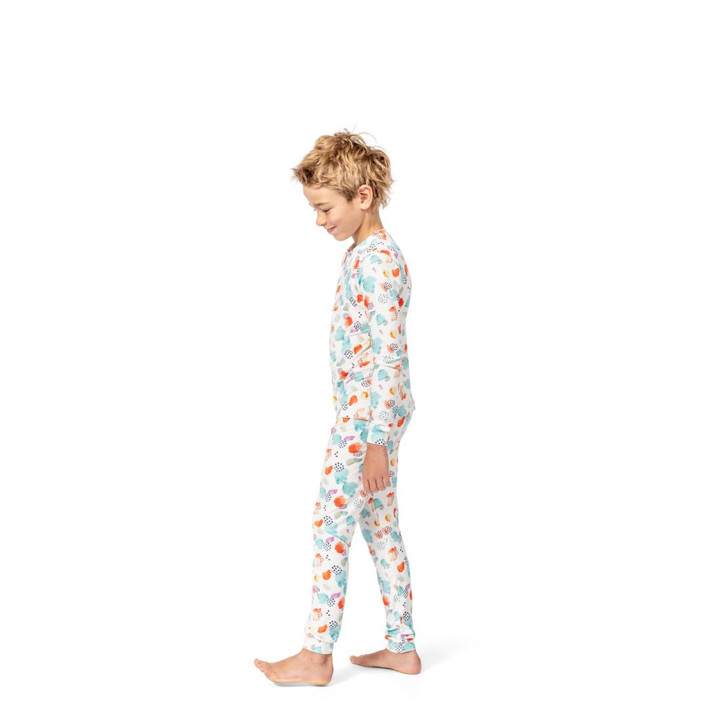 Boy wearing Confetti Cloud Kids Bamboo PJs in multicolor, side view
