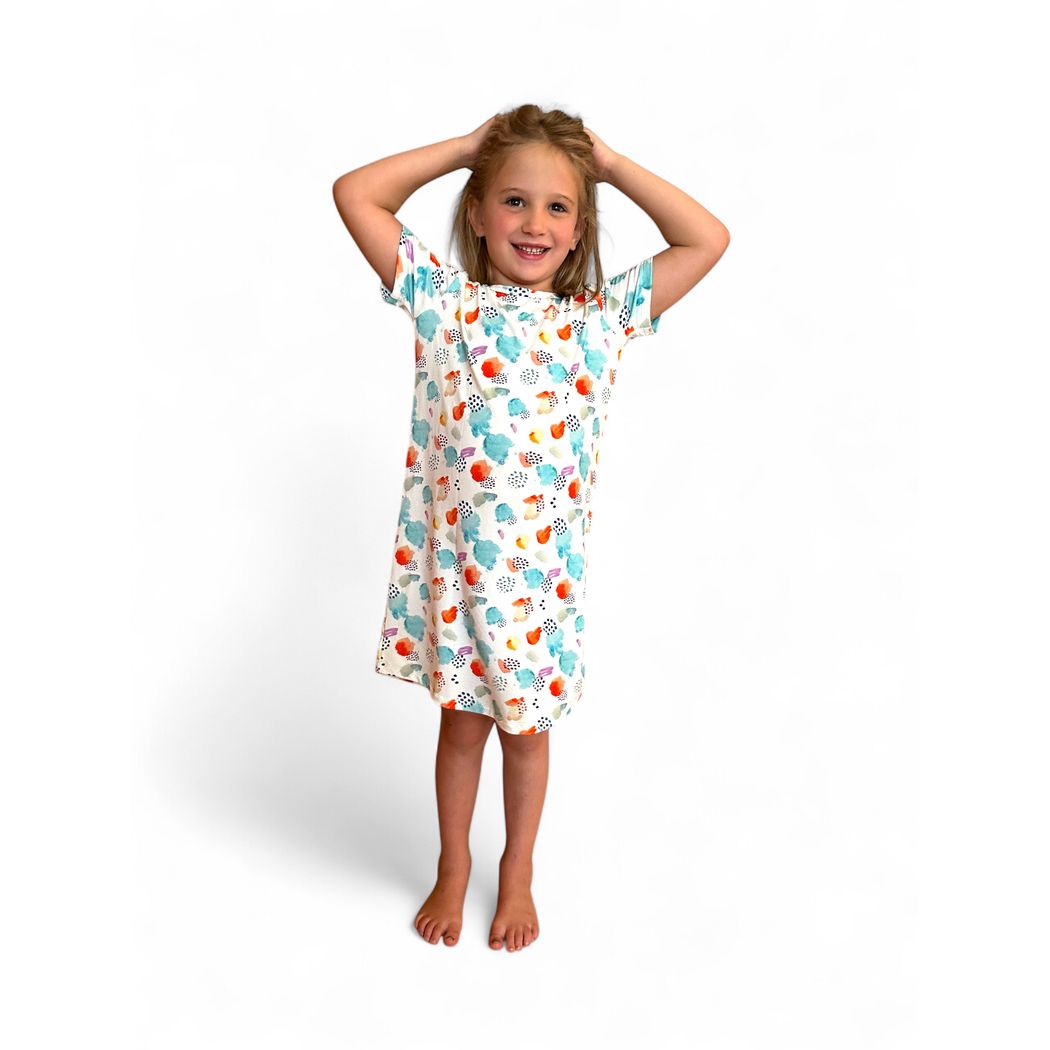 Girl wearing Confetti Cloud Kids Snuggle Dress in multicolor, front view