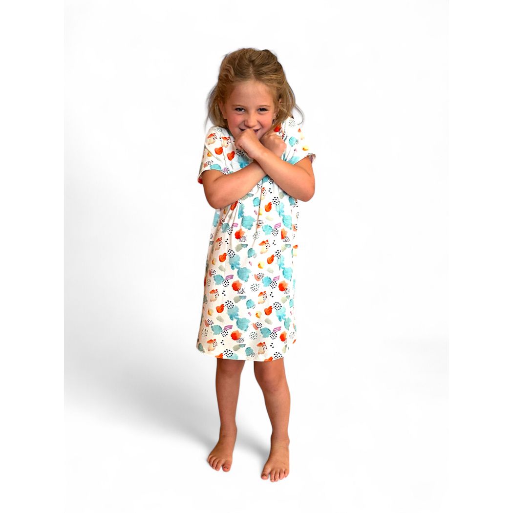 Girl wearing Confetti Cloud Kids Snuggle Dress in multicolor, front view