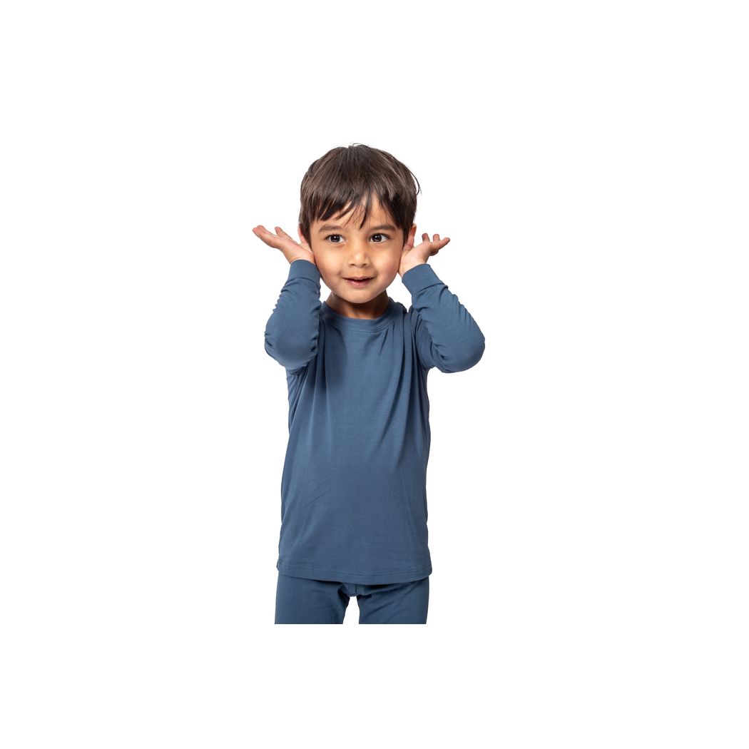 Toddler wearing Denim Kids Bamboo PJs in blue, front view