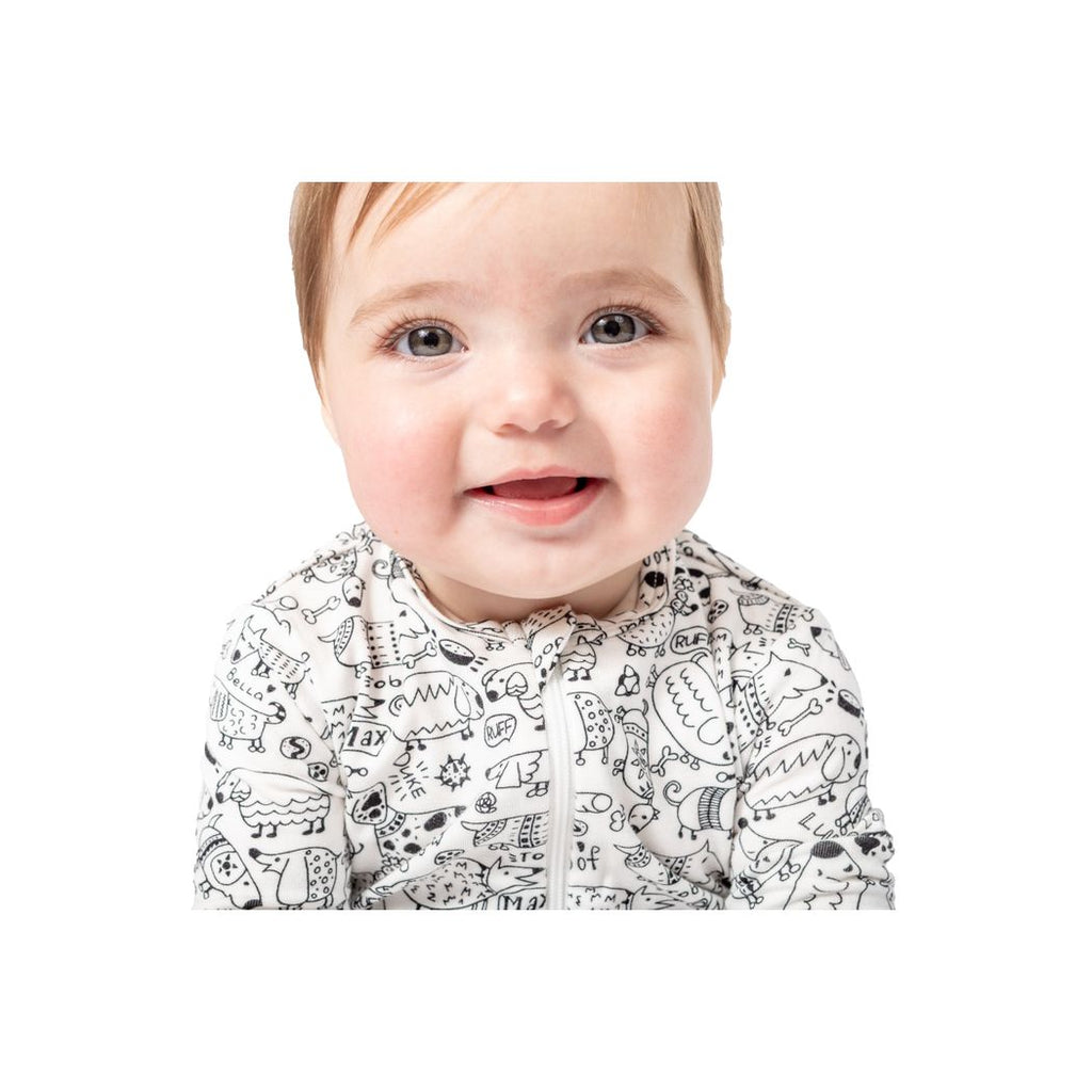 Baby wearing a black and white patterned outfit on a white background