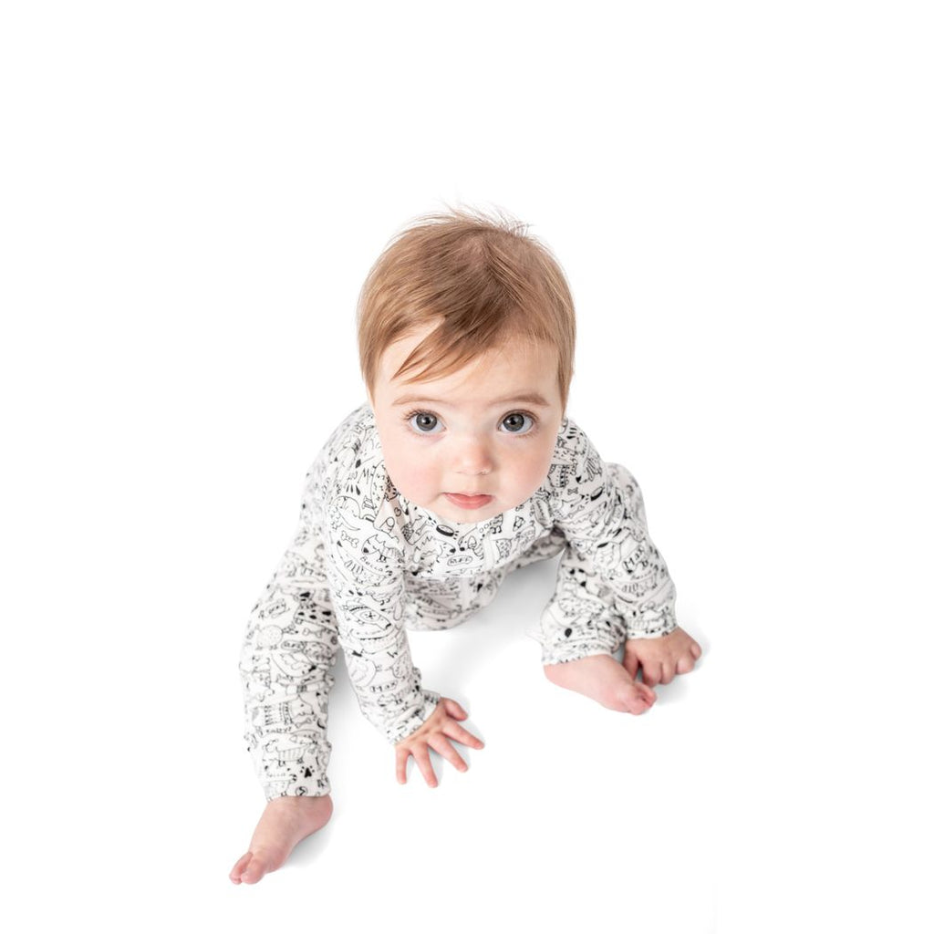 Baby wearing Dog Show Bamboo Zip Sleeper in neutral tones, front view
