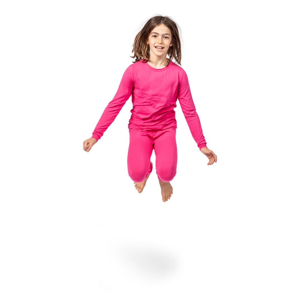 Girl wearing Fuchsia Kids Bamboo PJs in pink, front view