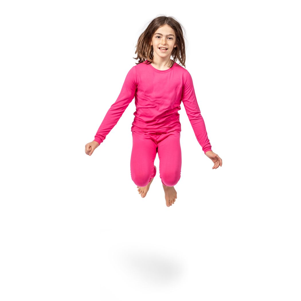 Girl wearing Fuchsia Kids Bamboo PJs in pink, front view