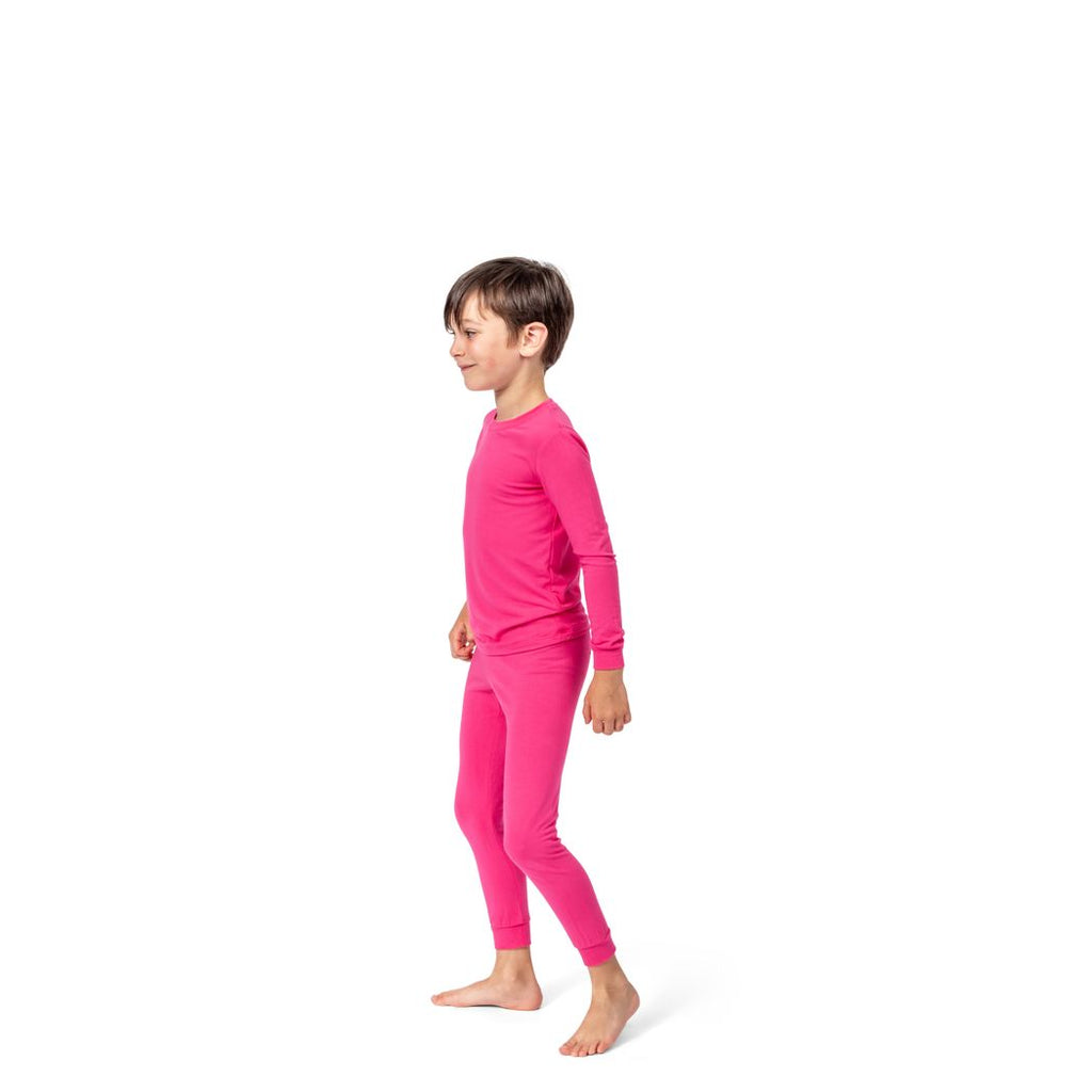 Boy wearing Fuchsia Kids Bamboo PJs in pink, side view