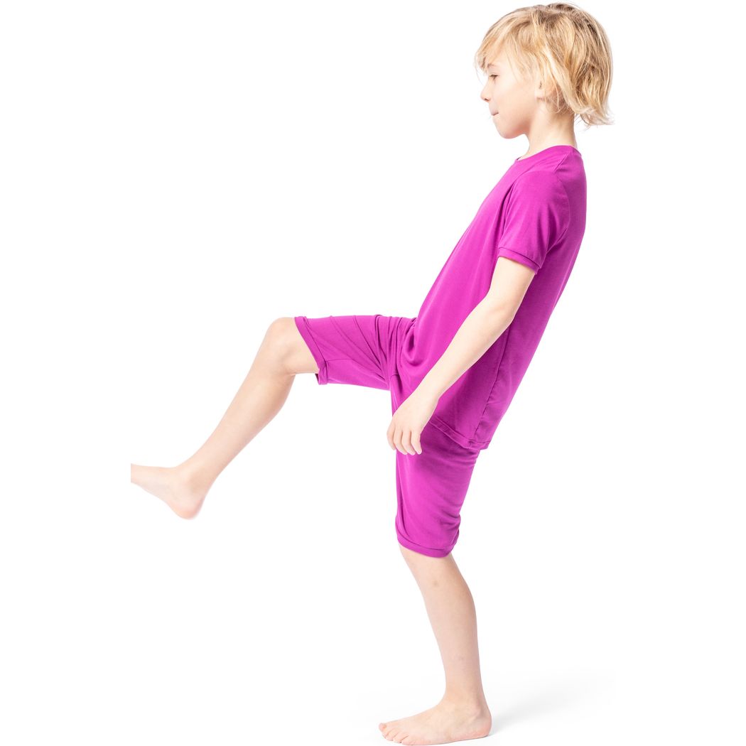 Boy wearing Fuchsia Bamboo Shorties PJ Set in pink, side view