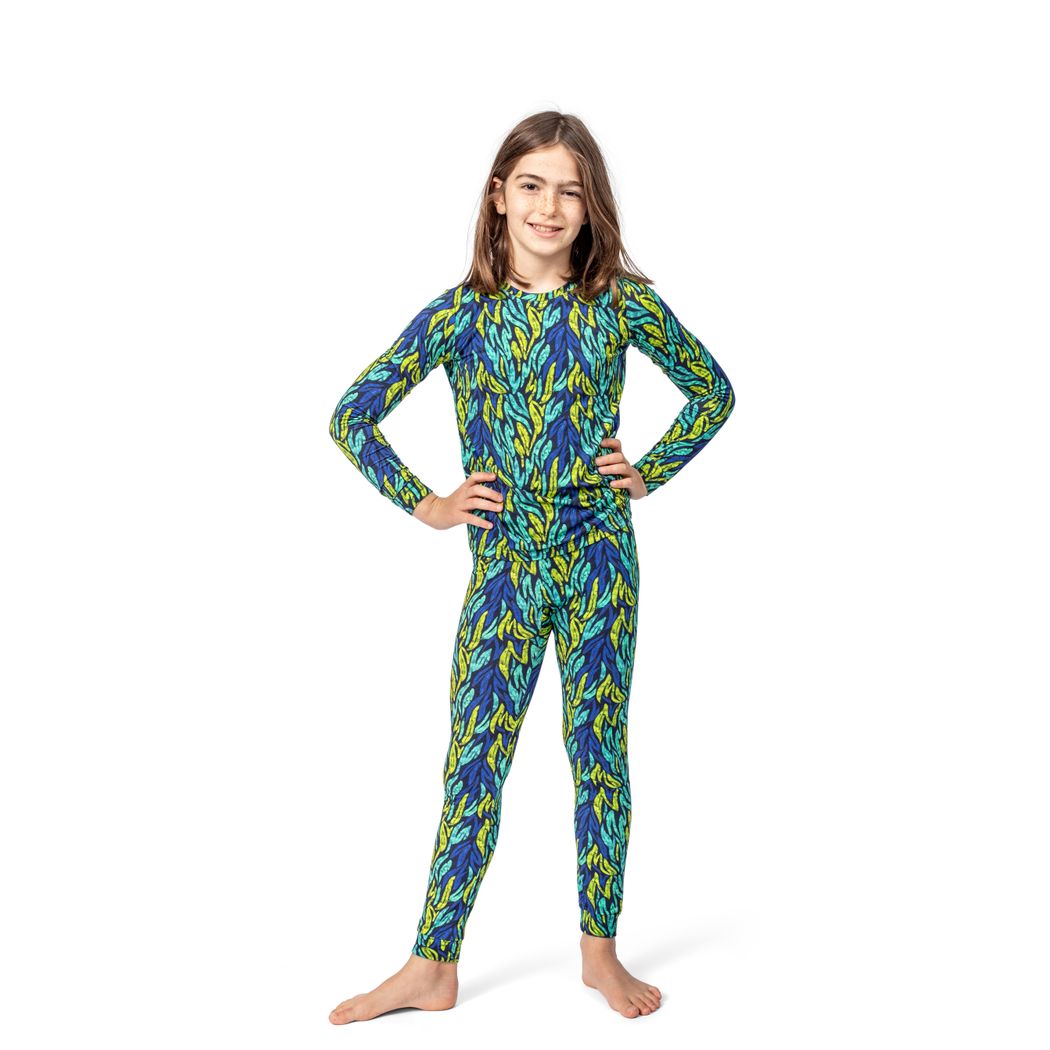 Child wearing a colorful patterned onesie on a white background