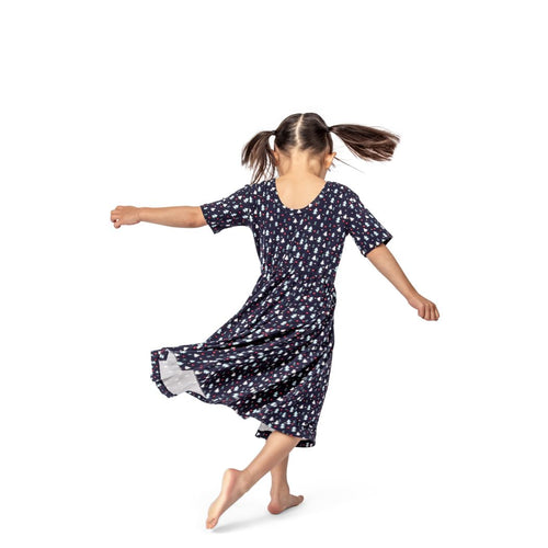 Girl wearing Midnight Pines Twirl Dress in navy, side view