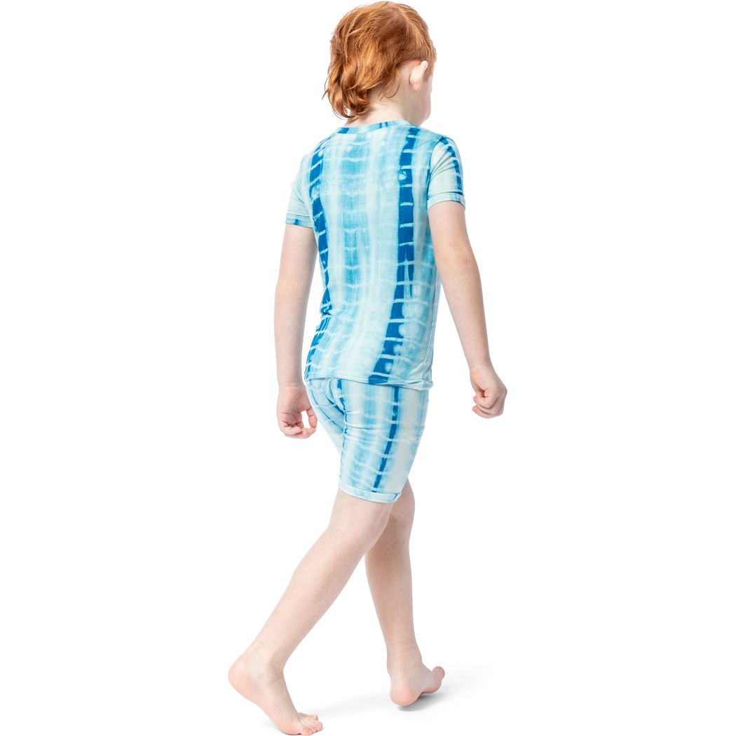 Girl wearing Mykonos Shibori Kids Bamboo Shorties PJ Set in blue, side view
