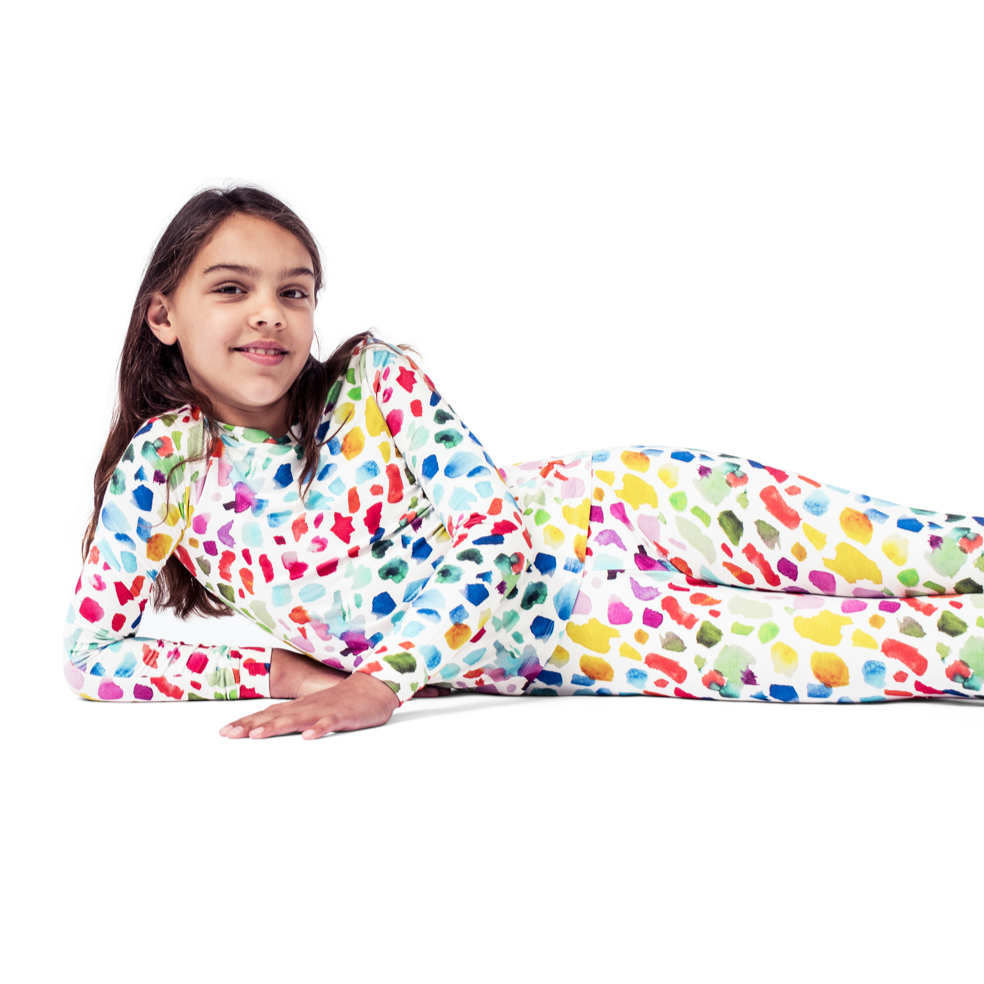 Girl wearing Paintbrush Kids Bamboo PJs in multicolor, lifestyle photo