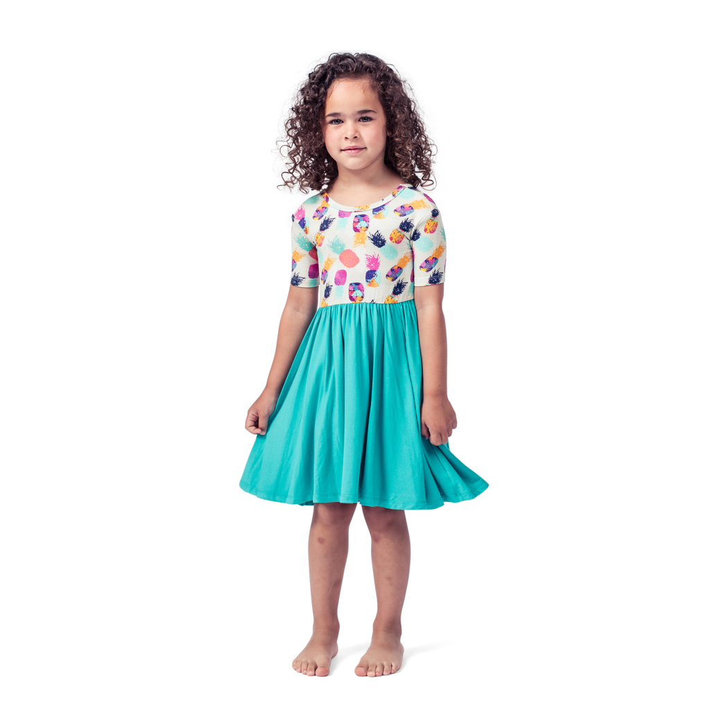 Girl wearing Pineapple Twirl Dress in multicolor, front view