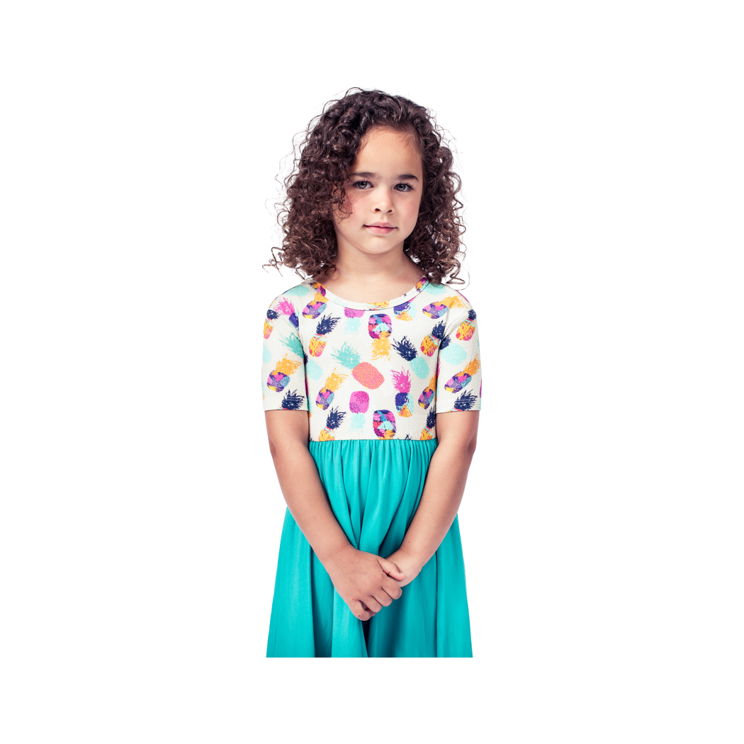 Girl wearing Pineapple Twirl Dress in multicolor, front view