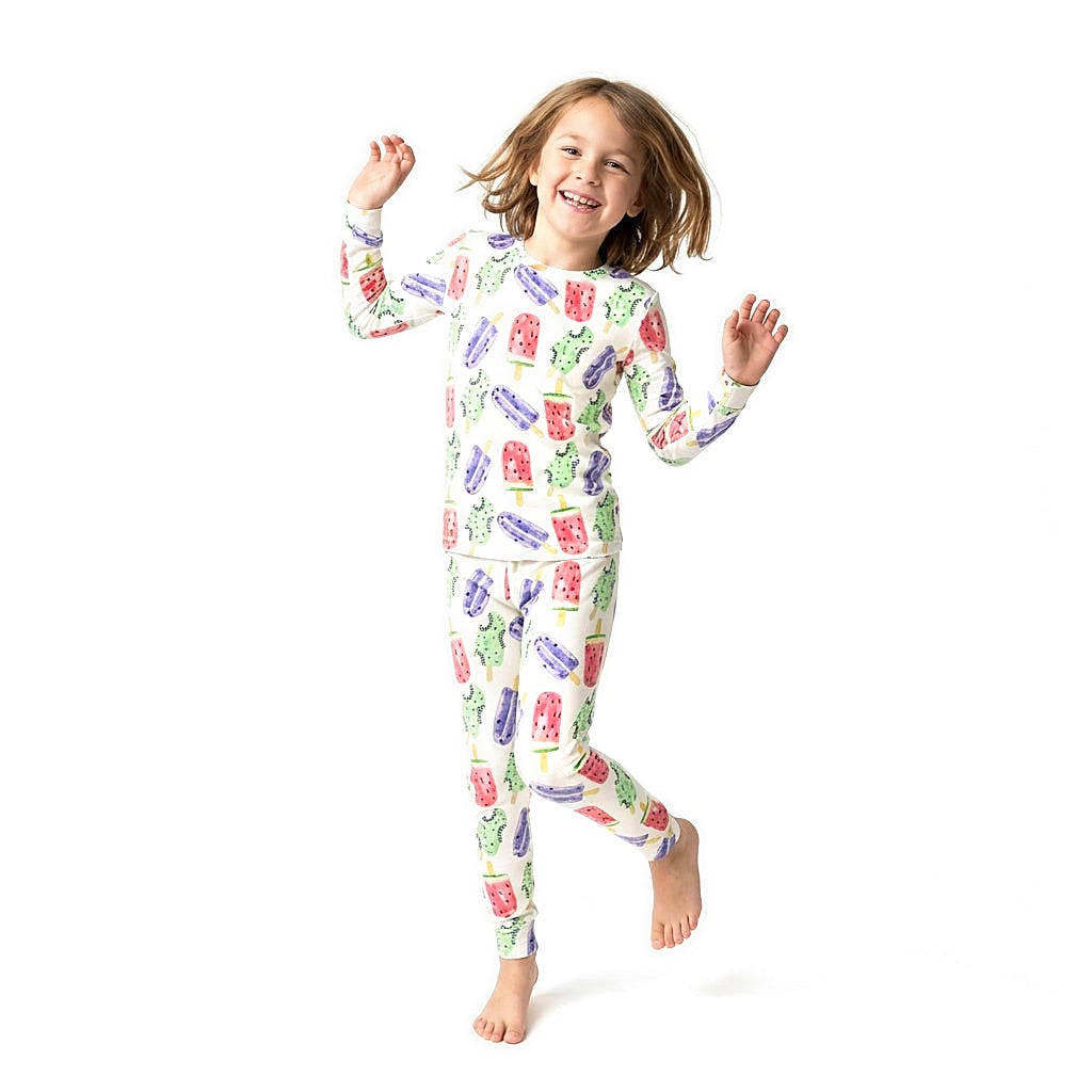 Girl jumping in Popsicle Bamboo PJs with watermelon, kiwi and grape popsicle print