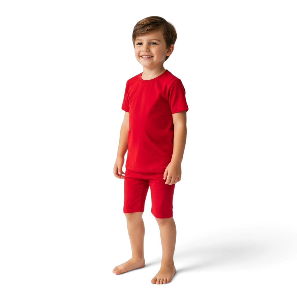 A young boy wearing a PIKA red bamboo shorties pajama set, featuring a soft, breathable, tagless design.
