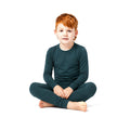 Boy sitting cross-legged in Sea Moss Bamboo PJs