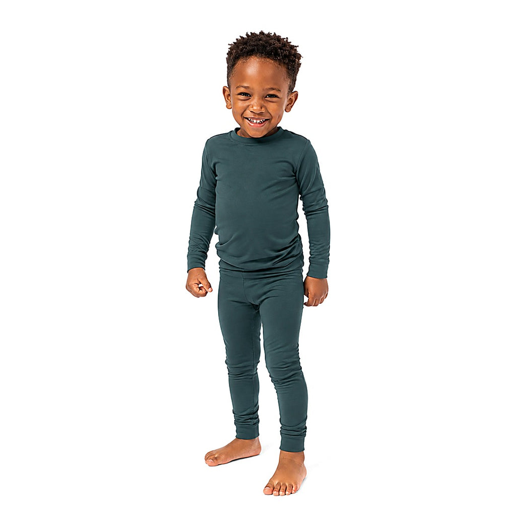 Smiling young boy wearing Sea Moss Bamboo PJs, front view