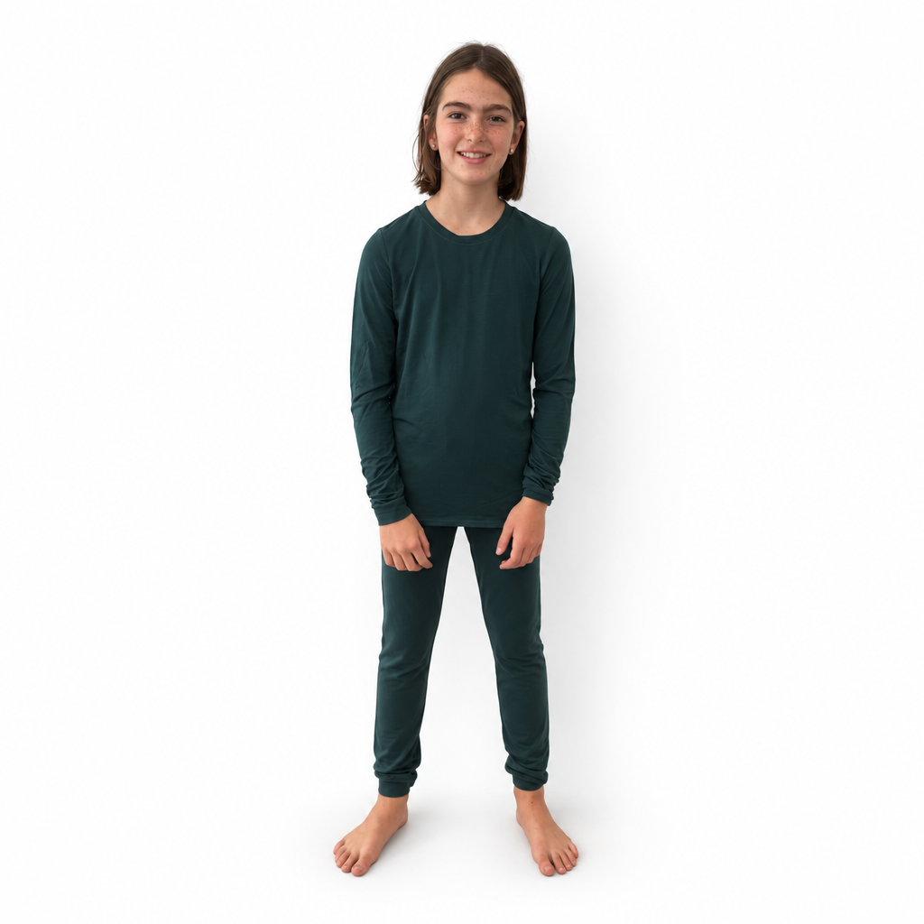 Girl wearing Sea Moss Bamboo PJs in dark green, long-sleeve top and jogger pants, front view