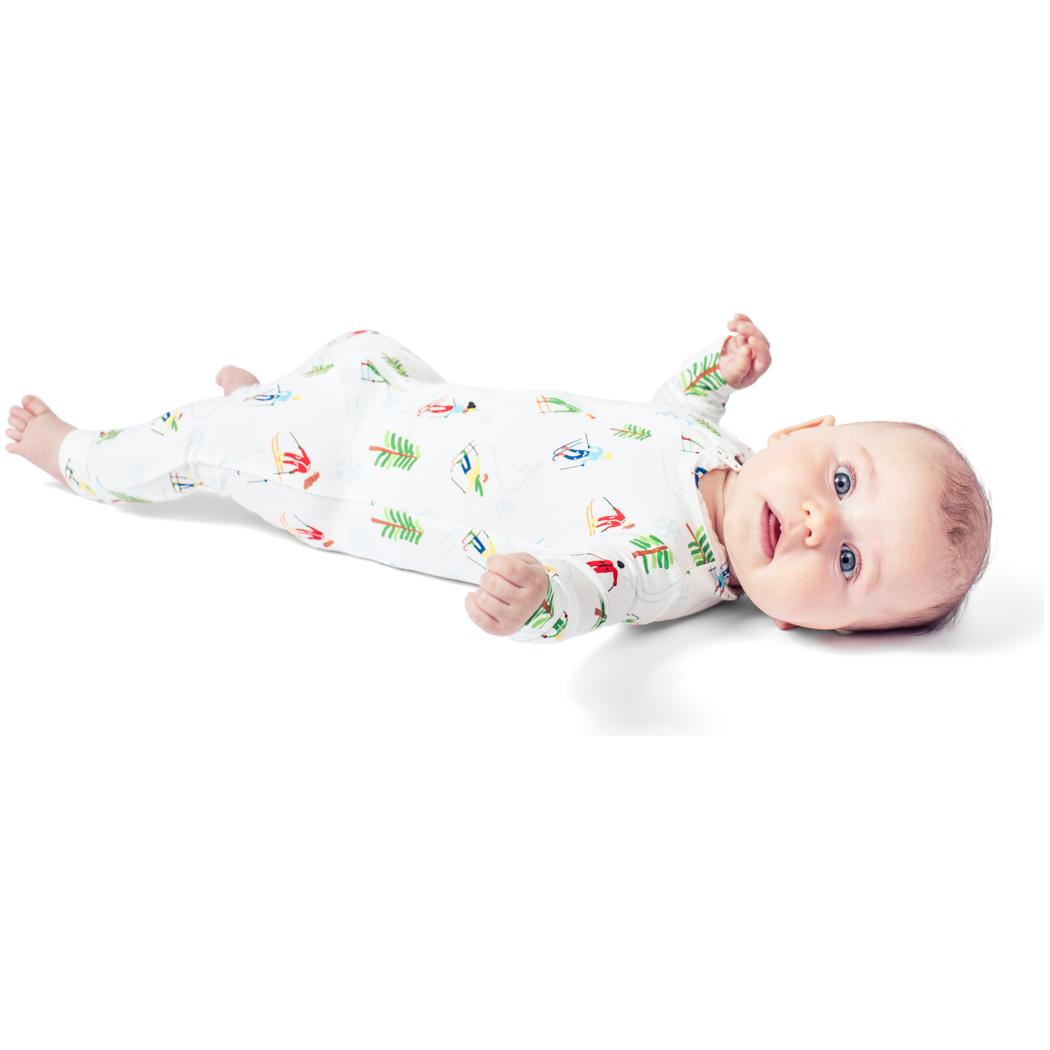 Baby wearing Skiers Bamboo Zip Sleeper in neutral tones, front view