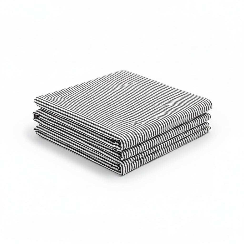Stripe Baby Bamboo Crib Sheet in black, styled product image