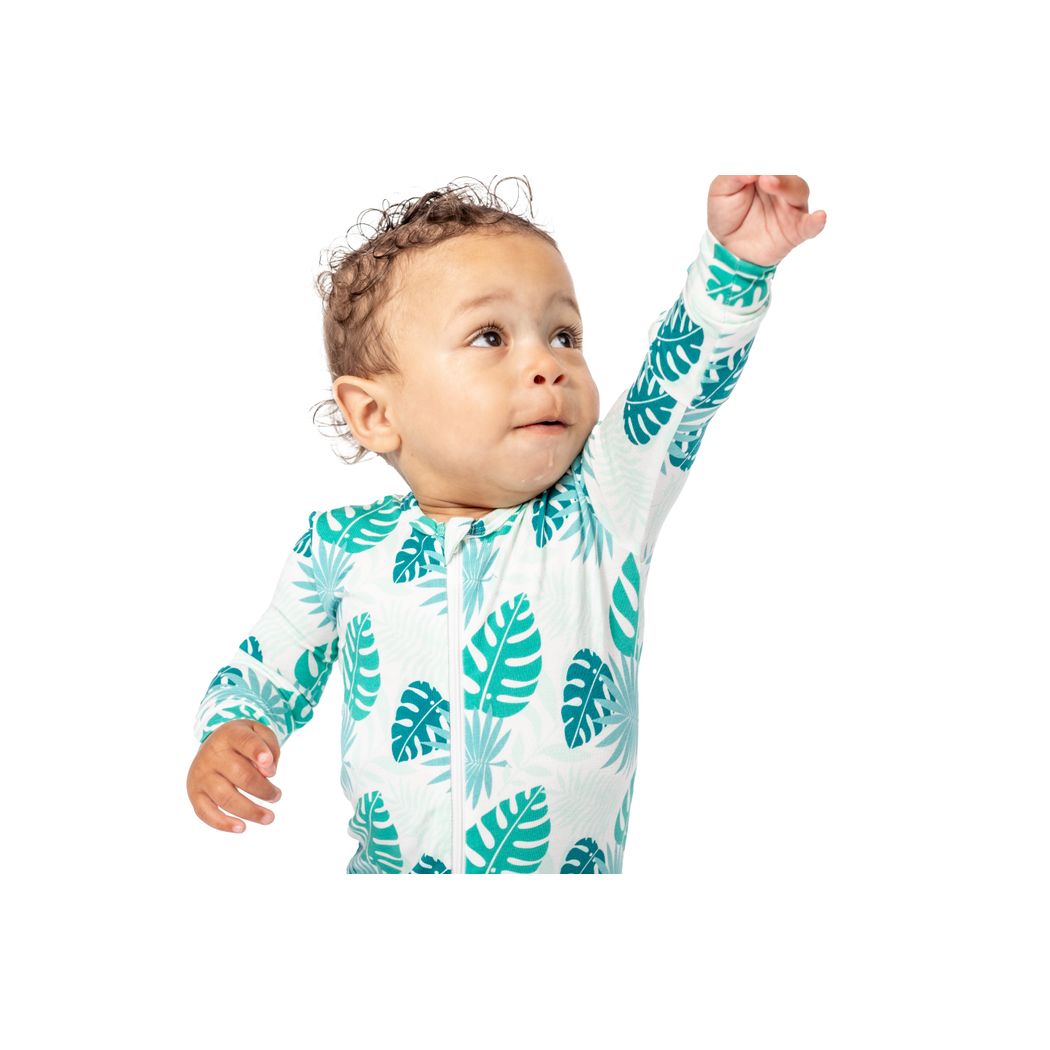 Baby wearing Tropicana Bamboo Zip Sleeper in mint, front view