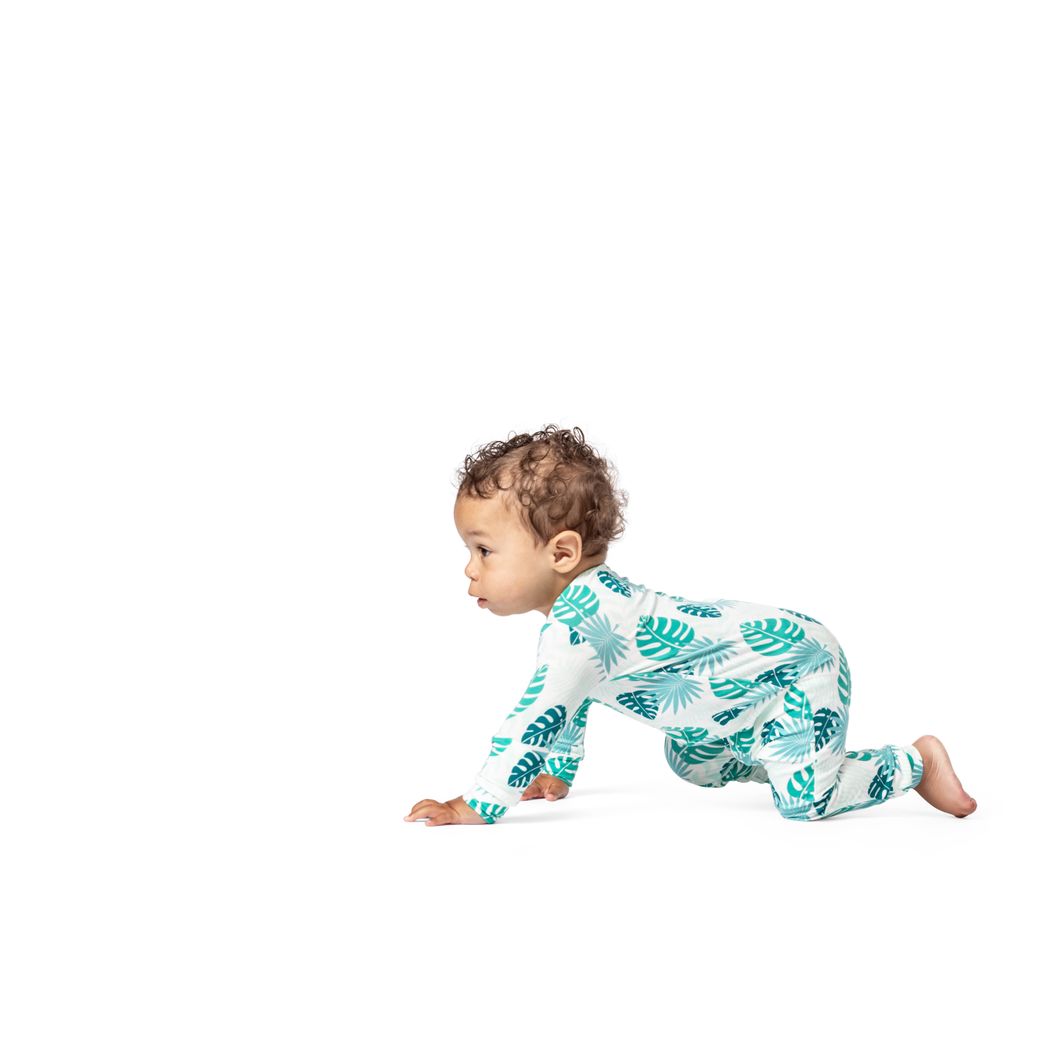 Baby wearing Tropicana Bamboo Zip Sleeper in mint, side view