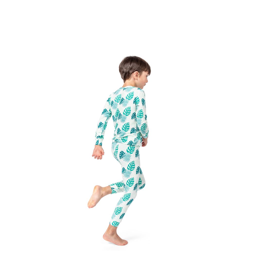 Boy wearing Tropicana Kids Bamboo PJs in mint, side view