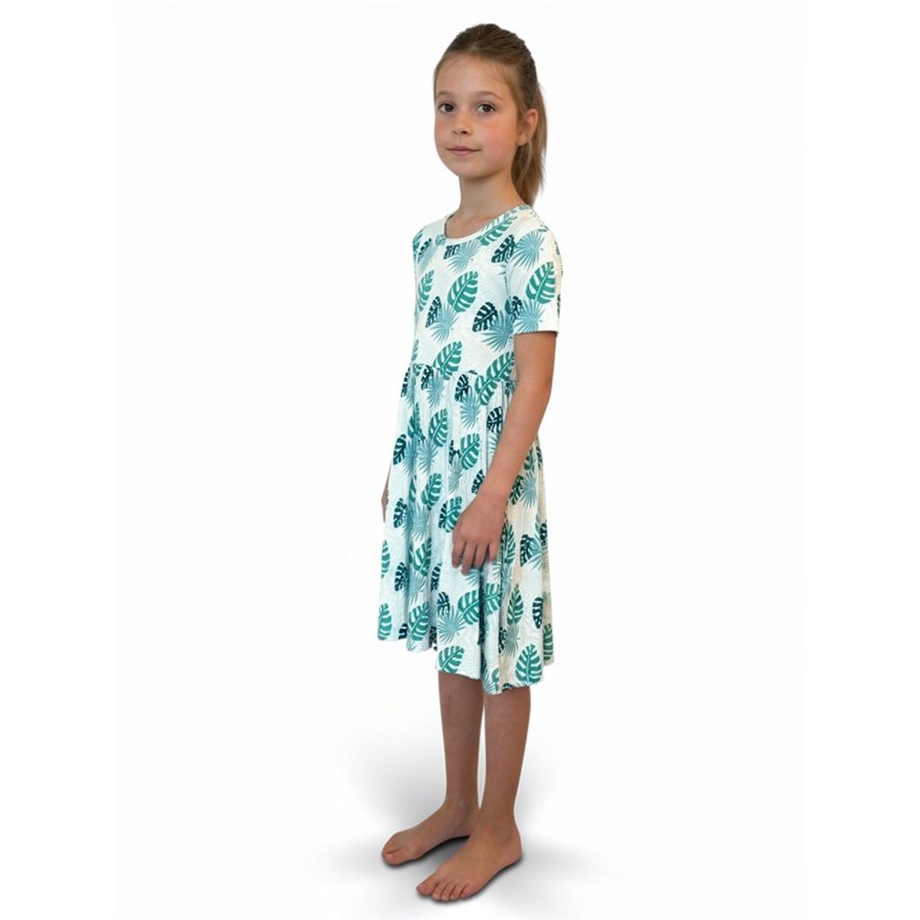 Girl wearing Tropicana Twirl Dress in mint, front view