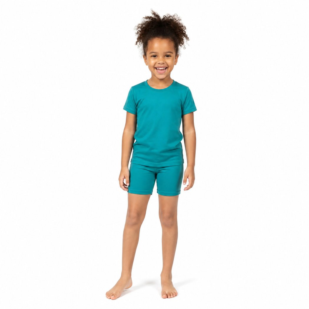 Child wearing a teal t-shirt and shorts set on a white background