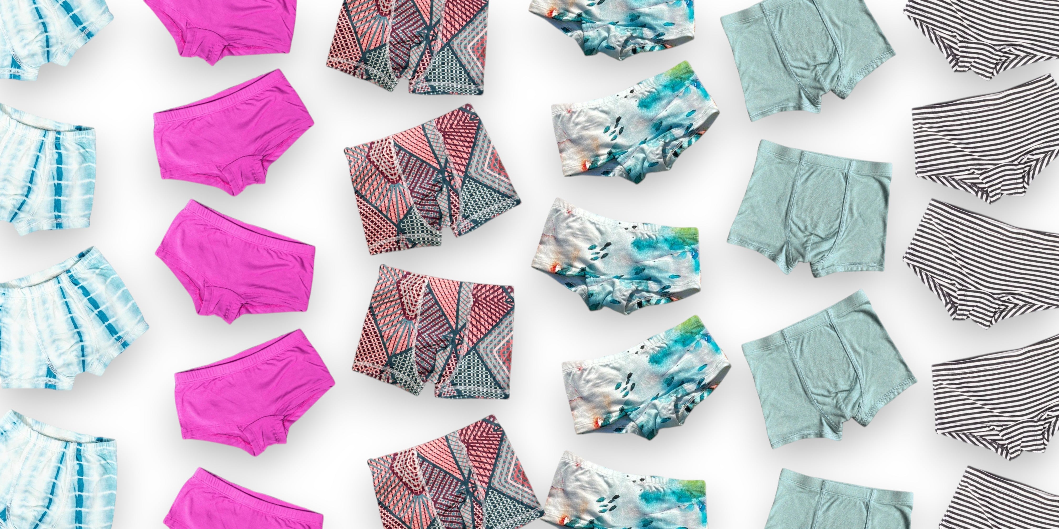 Various colorful underwear pieces arranged on a white background