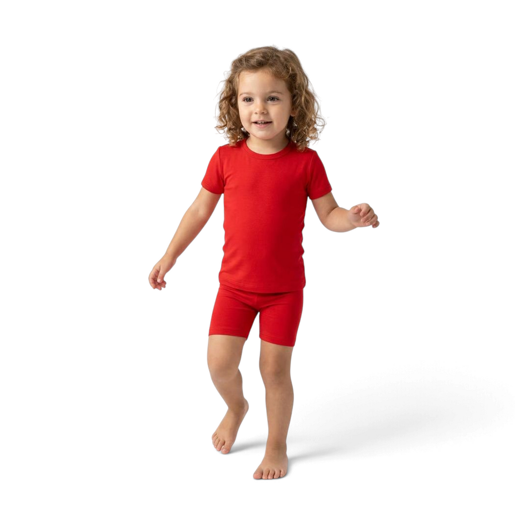 PIKA red bamboo shorties pajama set on a toddler, featuring a breathable, tagless, and sensory-friendly design.