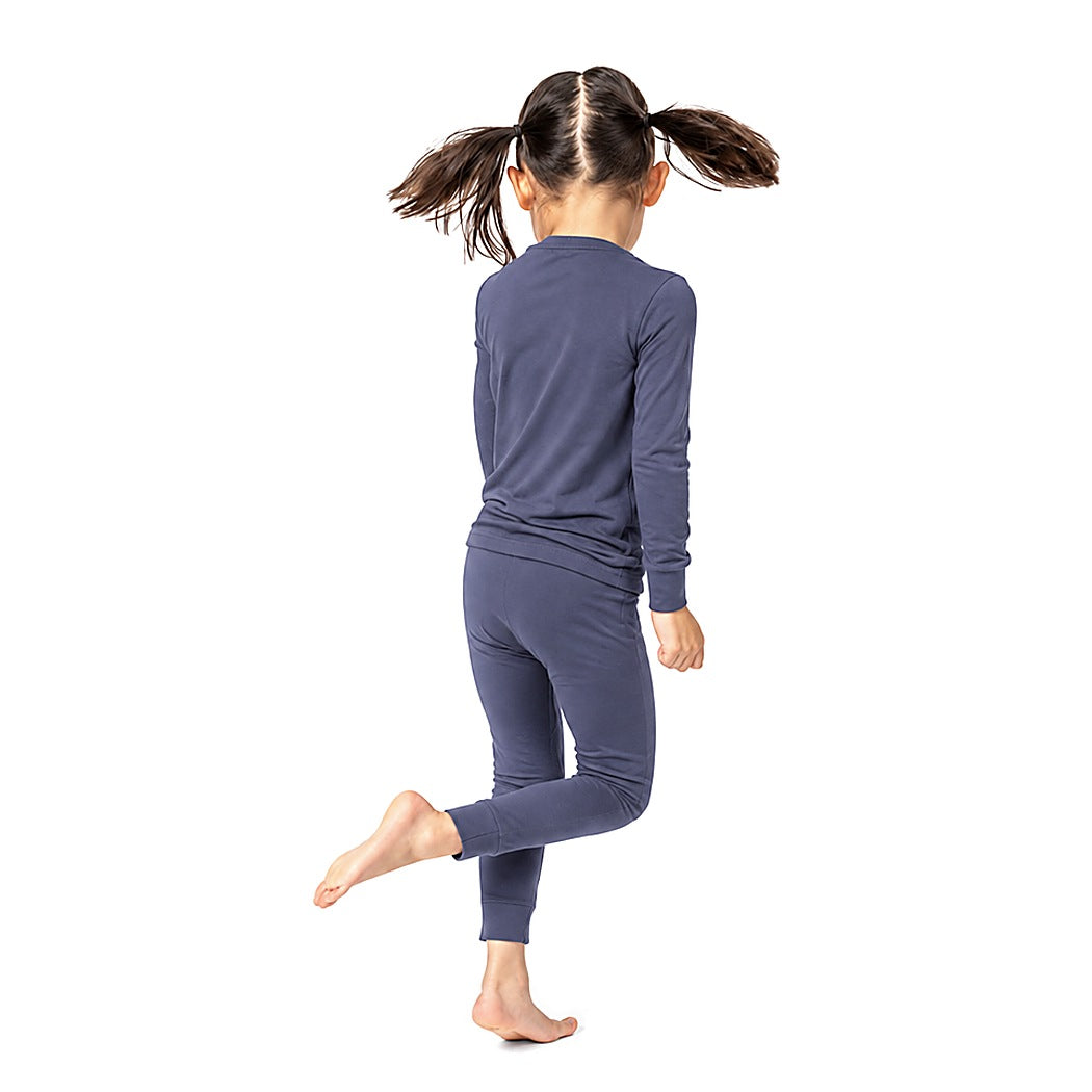 Girl in pigtails jumping in Vintage Indigo Bamboo PJs, back view