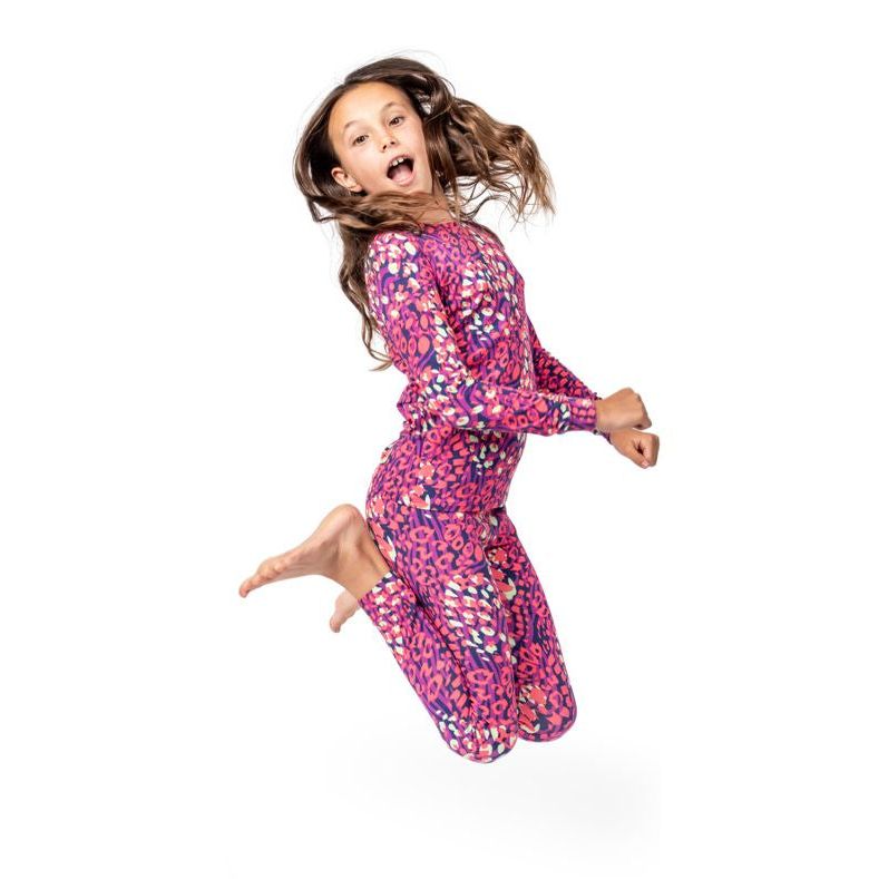 Child in a colorful outfit jumping on a white background
