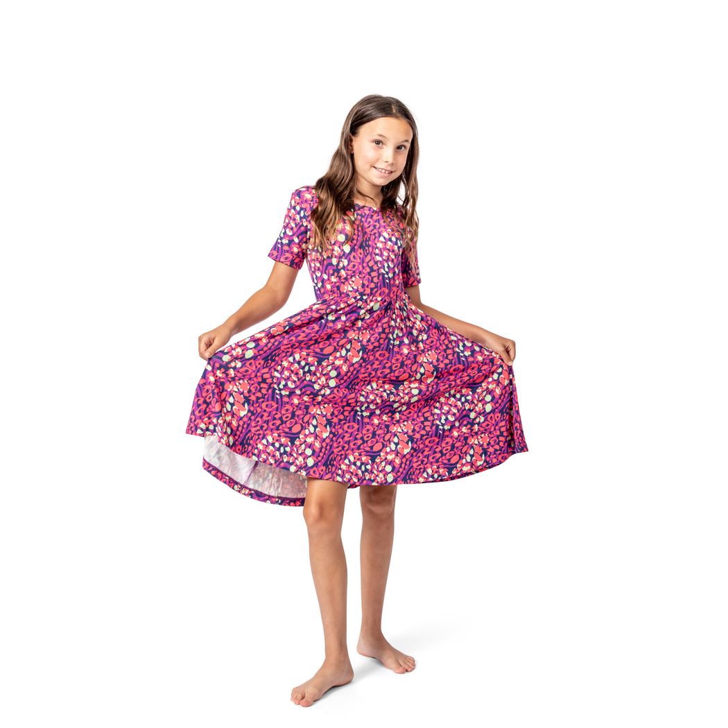 Girl wearing Wild Garden Twirl Dress in pink, front view