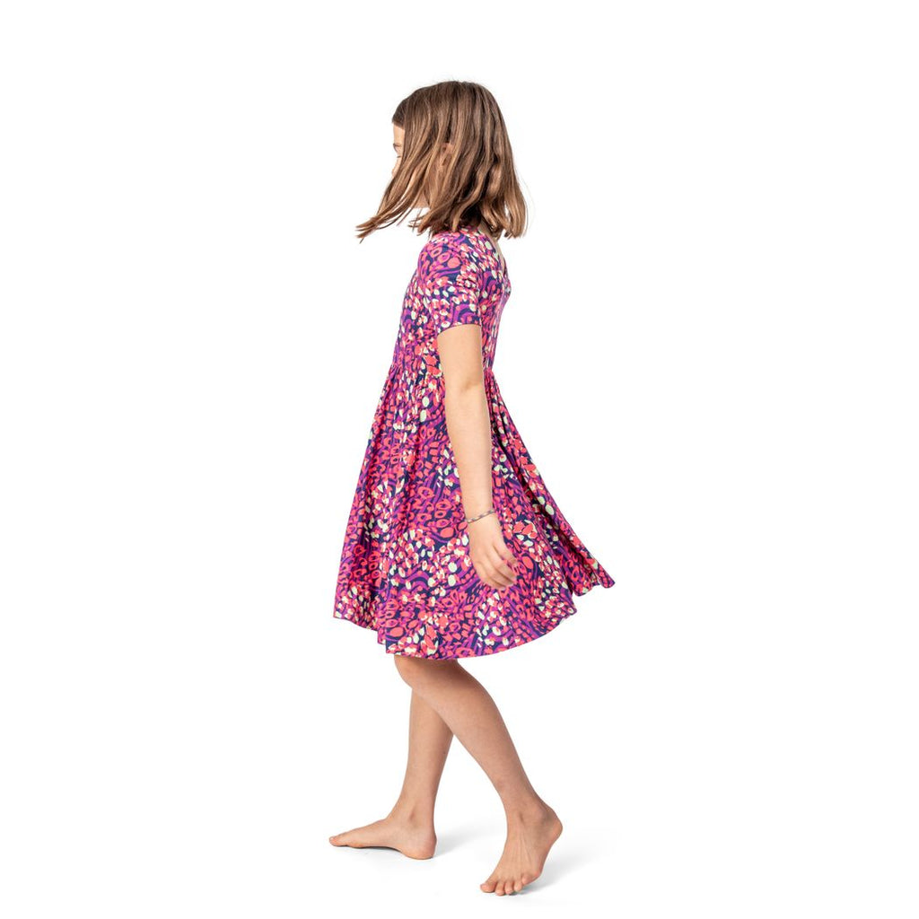 Girl wearing Wild Garden Twirl Dress in pink, side view