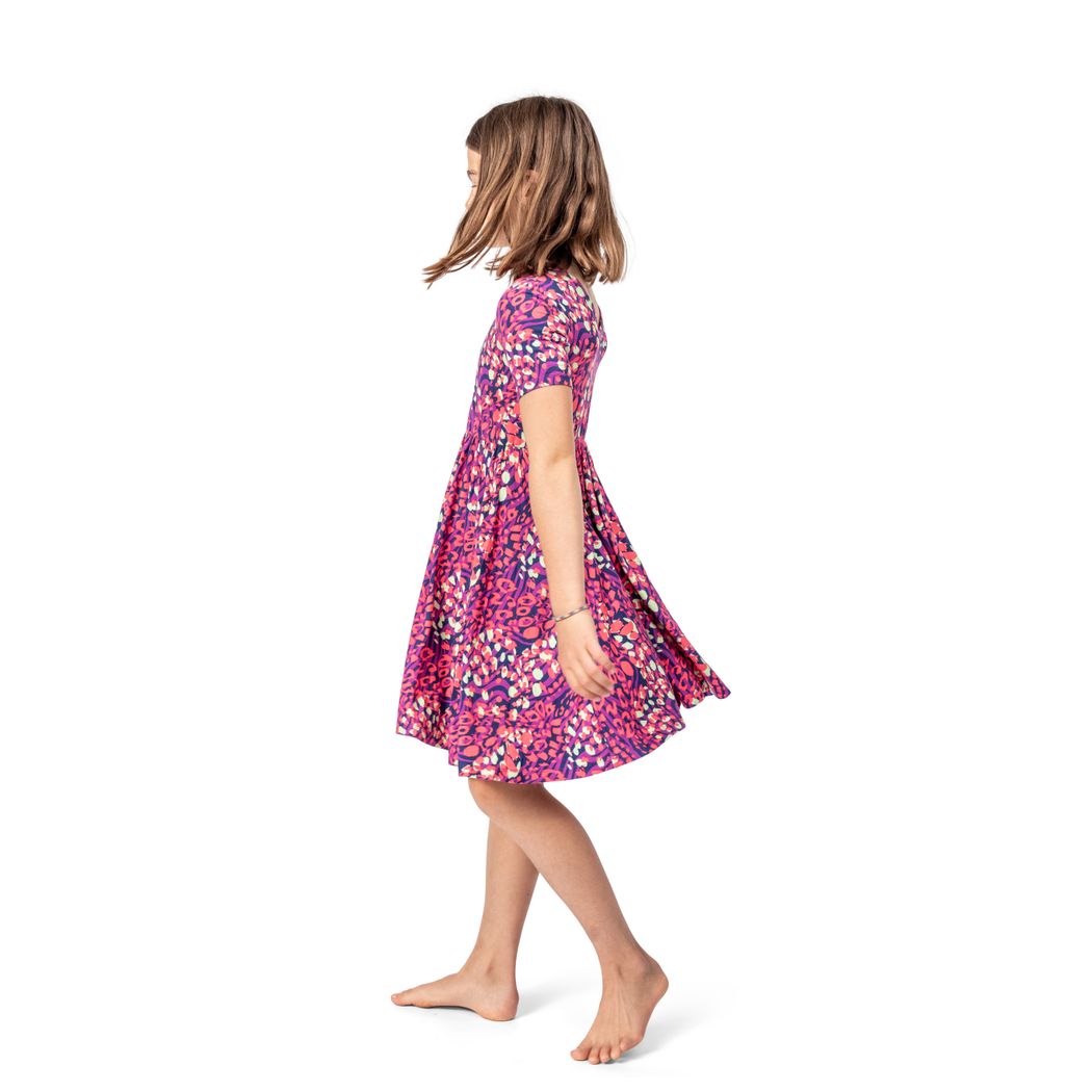 Girl wearing Wild Garden Twirl Dress in pink, side view